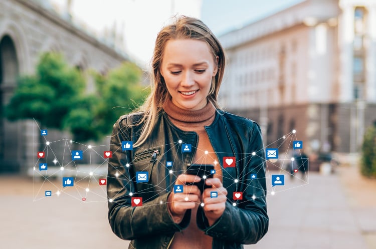 Woman smiling with iphone and tech apps around her