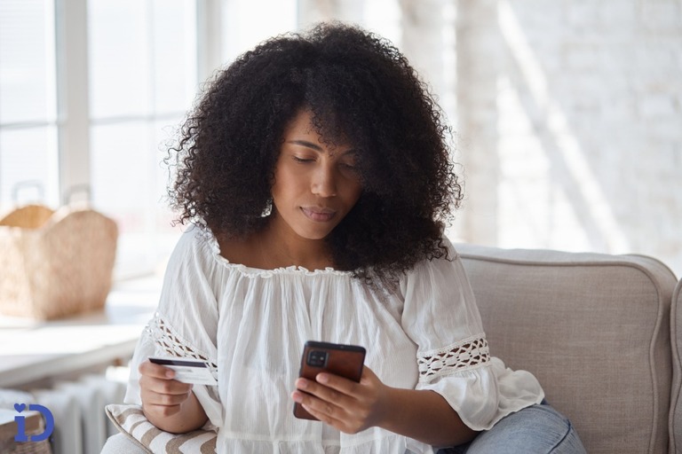 young black woman donating money on her phone