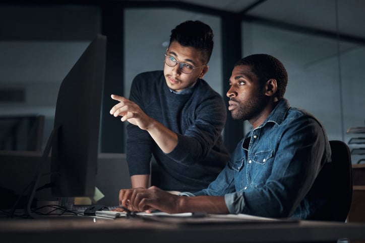 two men working together on a computer