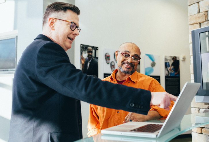 two men working together on a computer