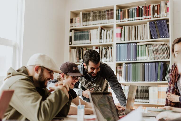 group of people working around a computer